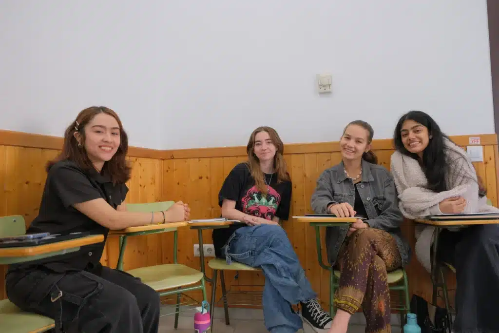 Four Verto students smiling together in a classroom