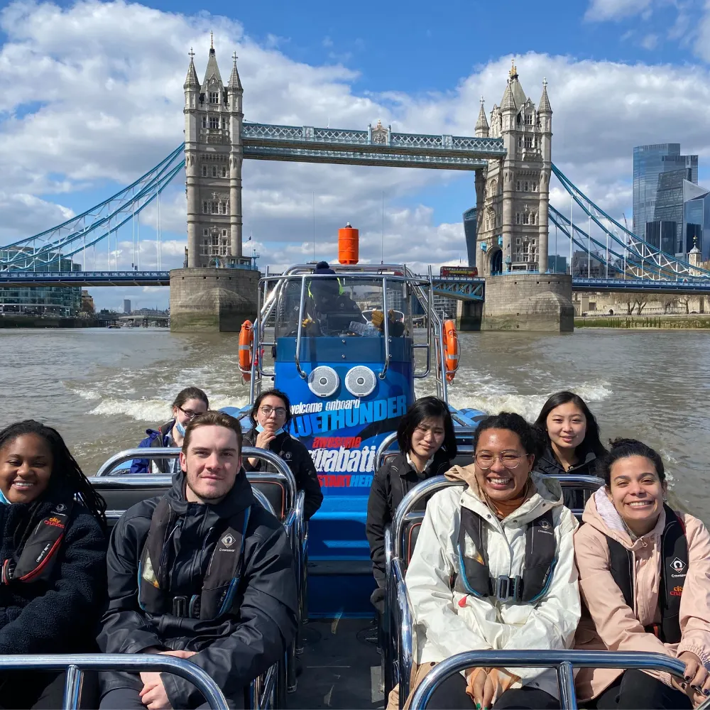 Verto students on a speedboat tour on the Thames River with Tower Bridge in the background