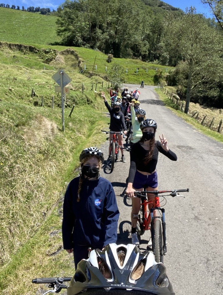 a group of students biking through the hills of Turrialba, Costa Rica