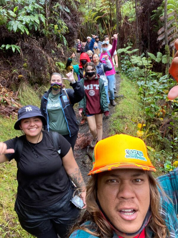 Happy students hiking through Volcanoes National Park