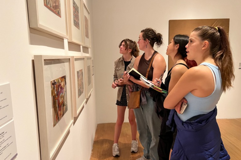 4 Students studying art in an art museum for class.