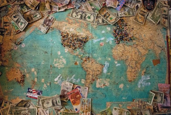 Photo of a world map with dollar bills and other currencies on top. Not sure how to afford study abroad? Here's tips for how to fund your study abroad!