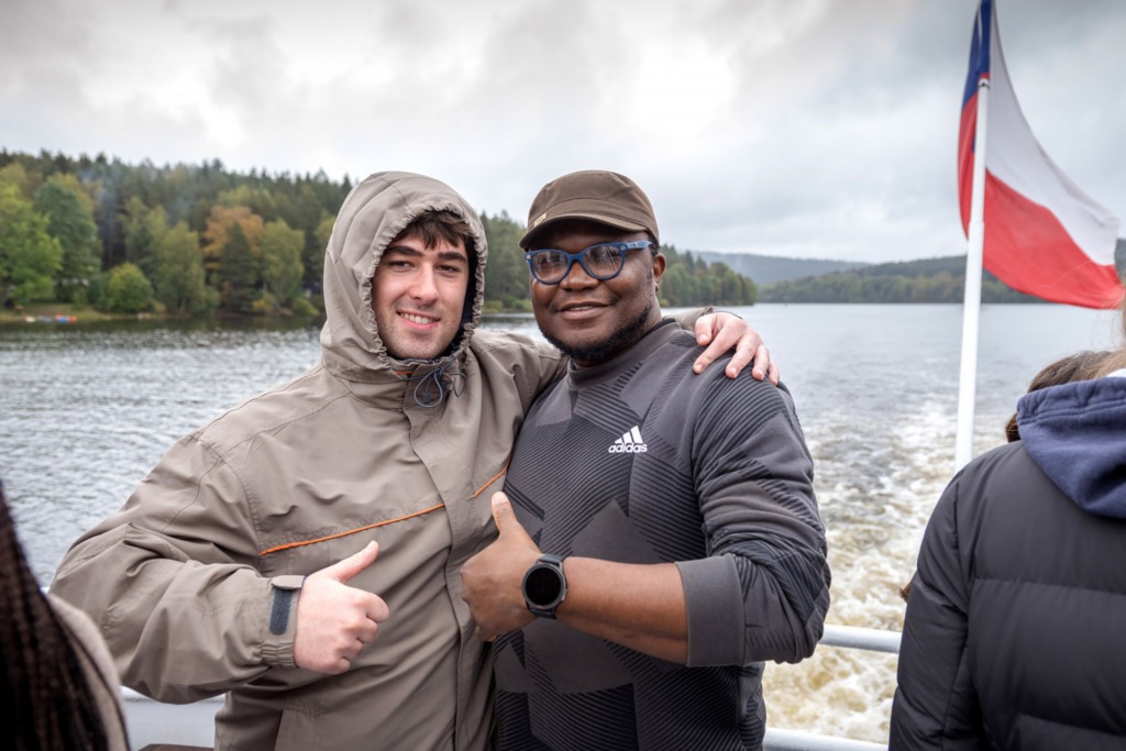 2 Students giving a thumbs up on a boat in the Czech Republic. 